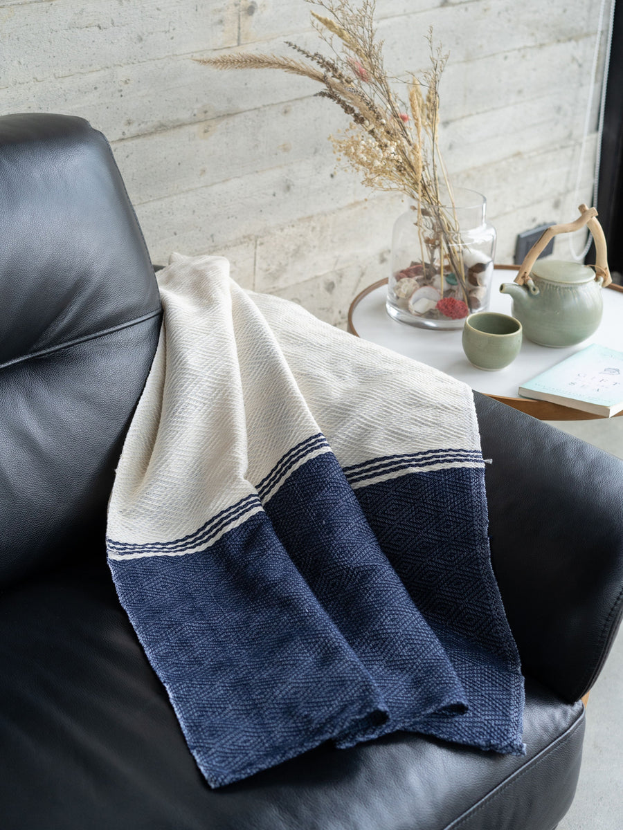 Releve Fashion WVN Living Handwoven Navy Cream Coast Throw Blanket and Towel Sustainable Luxury Fashion Conscious Clothing and Lifestyle Accessories Ethical Designer Brand Artisanal Handcrafted Beachwear Home Accessories Purchase with Purpose Shop for Good