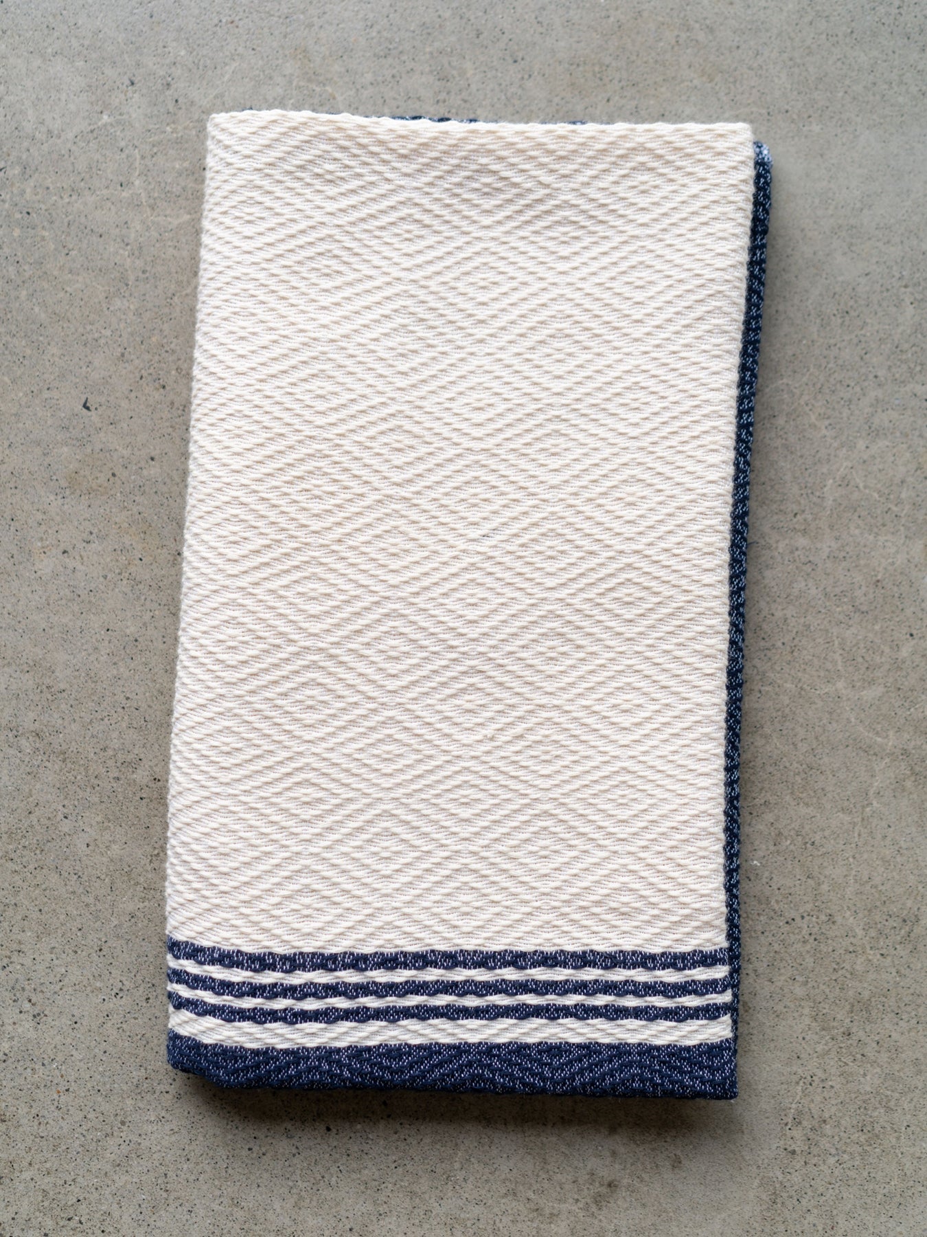Releve Fashion WVN Living Handwoven Navy Cream Coast Throw Blanket and Towel Sustainable Luxury Fashion Conscious Clothing and Lifestyle Accessories Ethical Designer Brand Artisanal Handcrafted Beachwear Home Accessories Purchase with Purpose Shop for Good