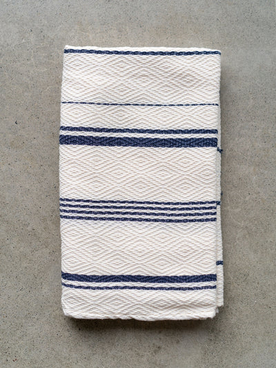 Releve Fashion WVN Living Handwoven Navy Cream Drift Throw Blanket and Towel Sustainable Luxury Fashion Conscious Clothing and Lifestyle Accessories Ethical Designer Brand Artisanal Handcrafted Beachwear Home Accessories Purchase with Purpose Shop for Good